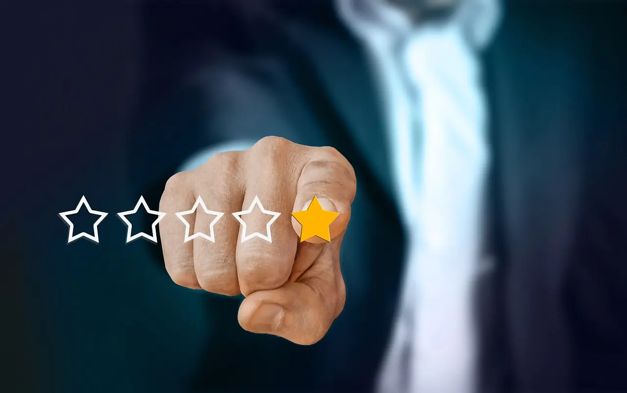Businessman pointing at a gold star in a five-star customer rating