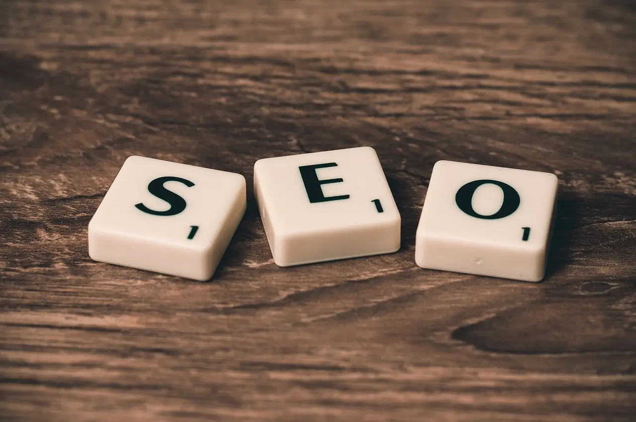 Wooden letter tiles spelling SEO on a table