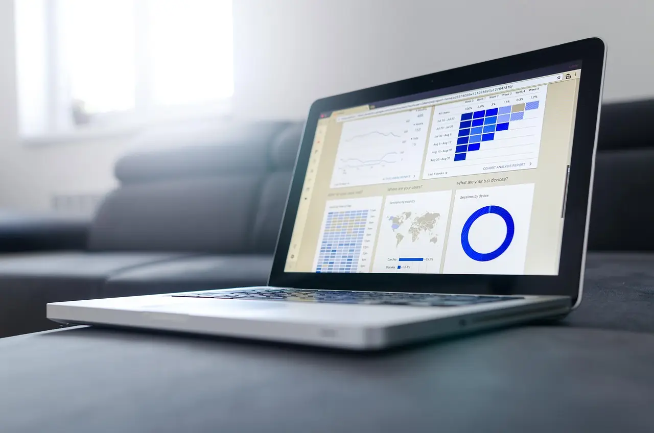 Laptop displaying an analytics dashboard with charts
